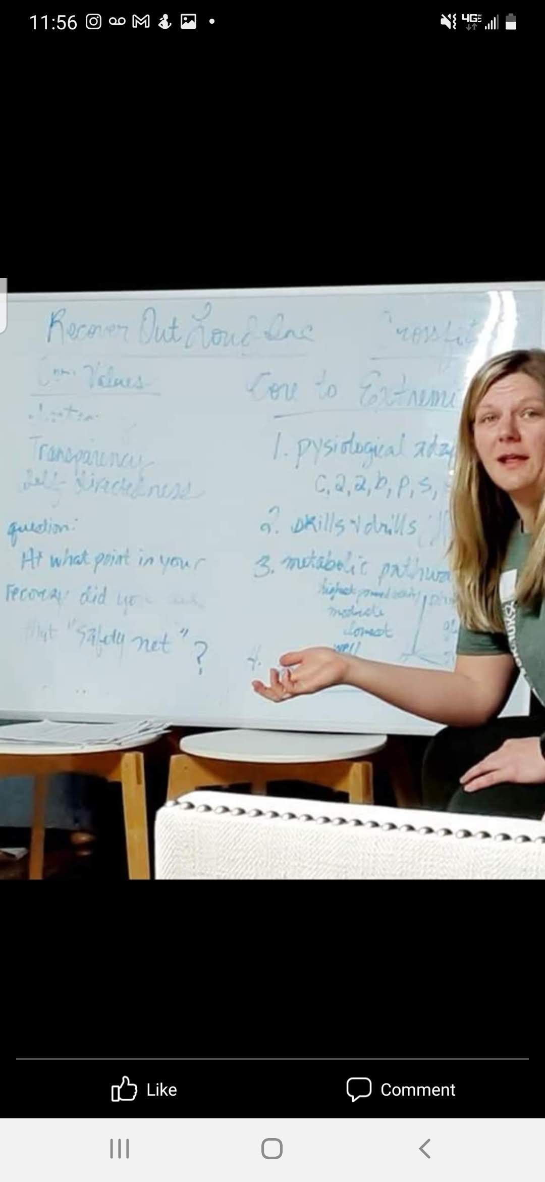 Instructor teaching fitness class at whiteboard
